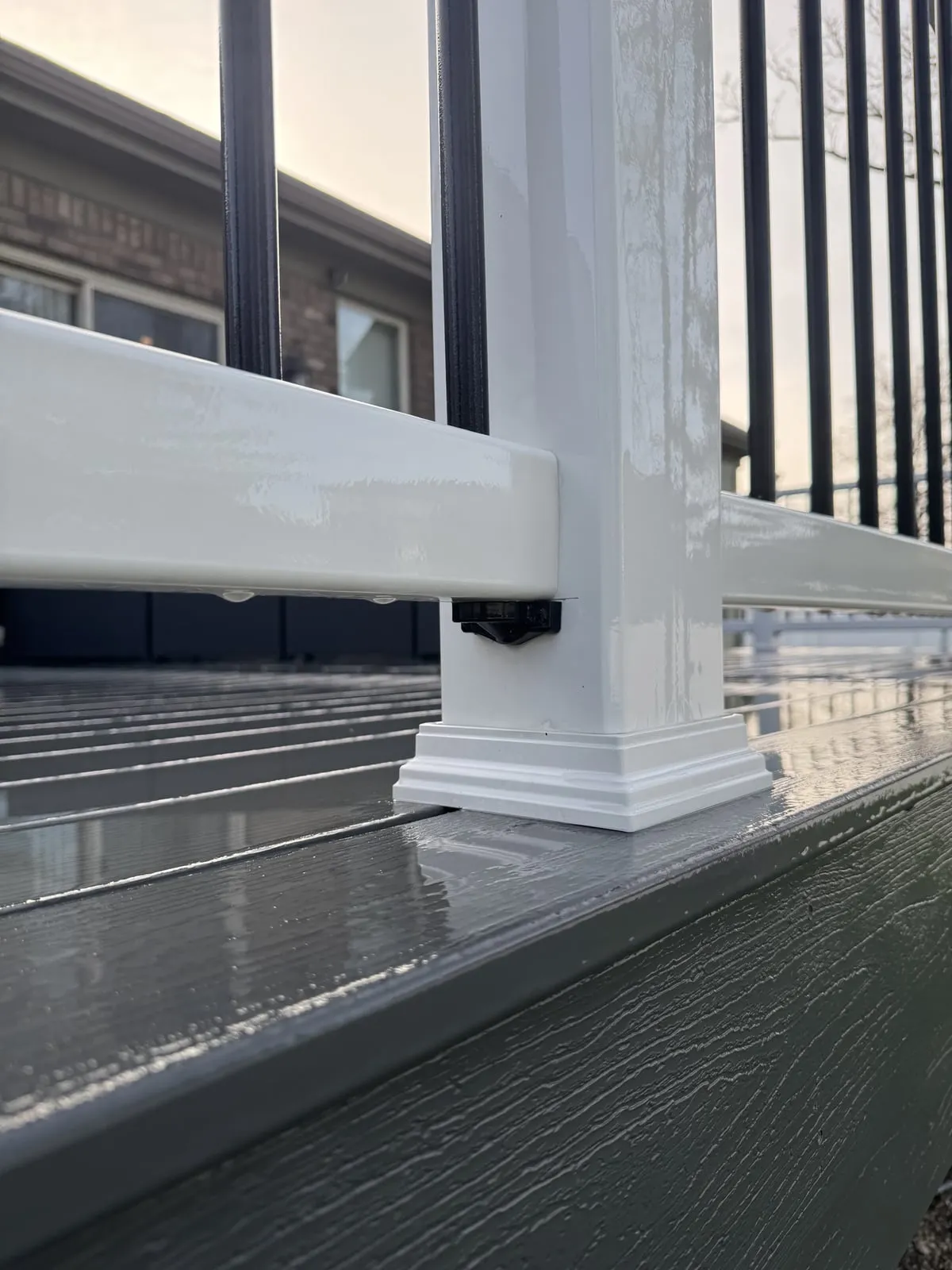 Freshly washed composite deck with white vinyl railing